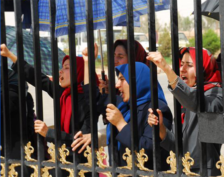 Camp Ashraf residents protest at the gate the forced entry of Iraqi Police into the Camp where some 3400 members of the main Iranian opposition group, the People’s Mpjahedin Organization of Iran (PMOI) are living in exile.