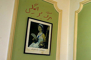 Graffiti in Persian reads 'Death to England' is seen above a picture of the Queen at the British Embassy in Tehran