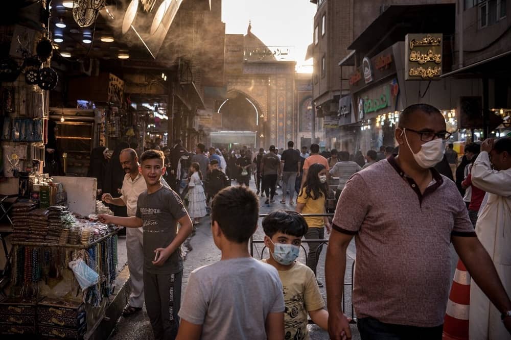 Tourists outside the shrine of Imam Hussein in Karbala, Iraq, in July.Credit...Sergey Ponomarev for The New York Times