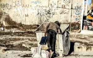 Iran-poverty-boy-trash bin