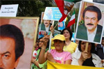 Supporters of the National Council of Resistance of Iran hold posters of Iranian opposition leaders Massoud Rajavi, and his wife Maryam Rajavi outside the United Nations as they voice their opposition to the Iranian government during the World Summit- AP photo