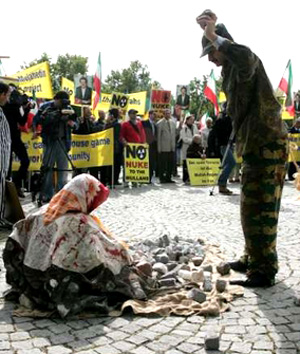 Supporters of the National Council of Resistance of Iran simulate a stoning in front of the U.N. building in Vienna where the International Atomic Energy Agency (IAEA) board of governors meeting takes place on Iranian nuclear program. Demonstrators demand a referral of Iran's nuclear file to the U.N. Security Council. (September 19, 2005) 
