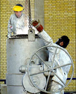 Two Iranians work at the zirconium production plant, part of the nuclear facilities in Isfahan in March 2005. Iran started a new round of converting uranium ore into the feedstock gas for making enriched uranium, a move likely to complicate diplomacy over Iran's disputed nuclear program, diplomats said.(AFP/File/Henghameh Fahimi)