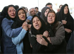 Iranian women react to losing loved ones in a plane crash on Tuesday, at the forensic department, in Tehran, Iran, Wednesday, Dec. 7, 2005. At least 115 people, most of them journalists, died when a military transport plane crashed into a 10-story apartment building near Tehran Mehrabad airport Tuesday as the pilot attempted an emergency landing after developing engine trouble. (AP Photo/Vahid Salemi) 