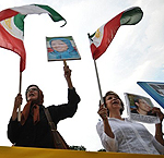 Photo: Supporters of the People's Mojahedin of Iran (PMOI/MEK), waving flags and pictures of Maryam Rajavi , demonstrate in front of the White House in Washington on July 17, 2009.
