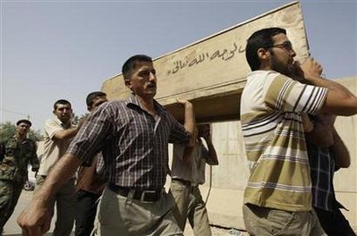 Residents carry the coffin of their relative who was killed in Baghdad's bombing on Wednesday outside a morgue in Baghdad, August 20, 2009