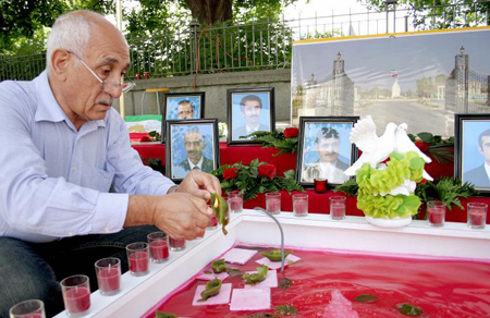 A Demonstrator lights candles to commemorate Iranians killed during the July 28 raid on Camp Ashraf. 