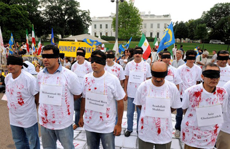 Demonstrators in black blindfolds and simulated bloody shirts with the names of Iranian exiles being detained by Iraq gather in front of the White House in Washington August 8, 2009. The rally was held in support of Iranian exiles in Camp Ashraf in Iraq who have been forcibly removed and detained by Iraqi forces, resulting in deaths and injuries.