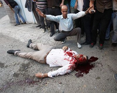 Protesters gathered around body of Ali Hassnpour shortly after he was shot by Iranian regime agents on June 15, 2009