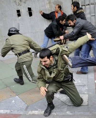 State Security Forces are kicked and pushed by protesters during clashes in Tehran. Iranian regime's security forces have killed several protesters in a fierce crackdown on mass anti-regime demonstrations in Tehran,