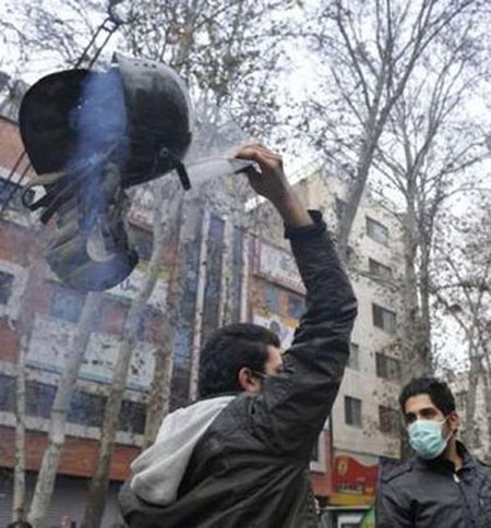 An Iranian protestor holds a helmet confiscated during clashes with police forces in central Tehran December 27, 2009.