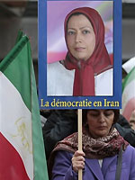 A woman holds a placard showing Maryam Rajavi, head of the Iranian opposition group National Council of Resistance, with writing on placard in French reading, "Democracy in Iran", during a demonstration outside the Italian Parliament, in Rome, Thursday, Feb. 11, 2010. 