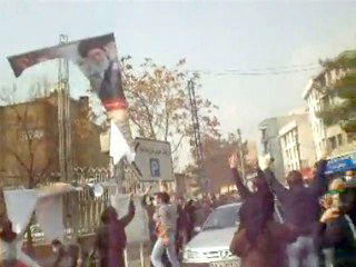  Portraits ofKhomeini and Khameneitorn down, stomped on during Feb. 11 protests