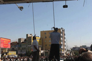 Two hanged in public in Kermanshah by a bus driving away as two men stood on it with ropes around their necks fixed to a bridge, Kermanshah, Iran, August 7, 2014.