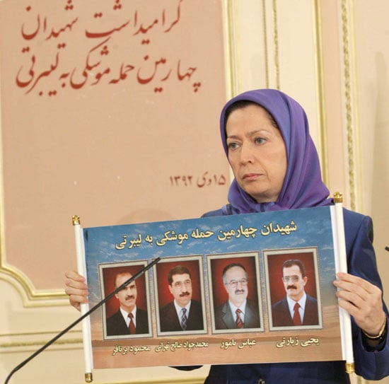 Maryam Rajavi, President-elect of the Iranian Resistance holds photos of four PMOI (MEK) members  killed in December 26, 2014 missile attack on Camp Liberty, Iraq.