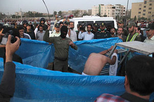 A man being lashed in public in Iran before being hanged, August 6, 2014. 
