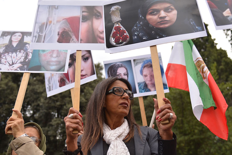People demonstrate against violence against women, in front of the Iranian embassy in Rome, Oct. 29, 2014.