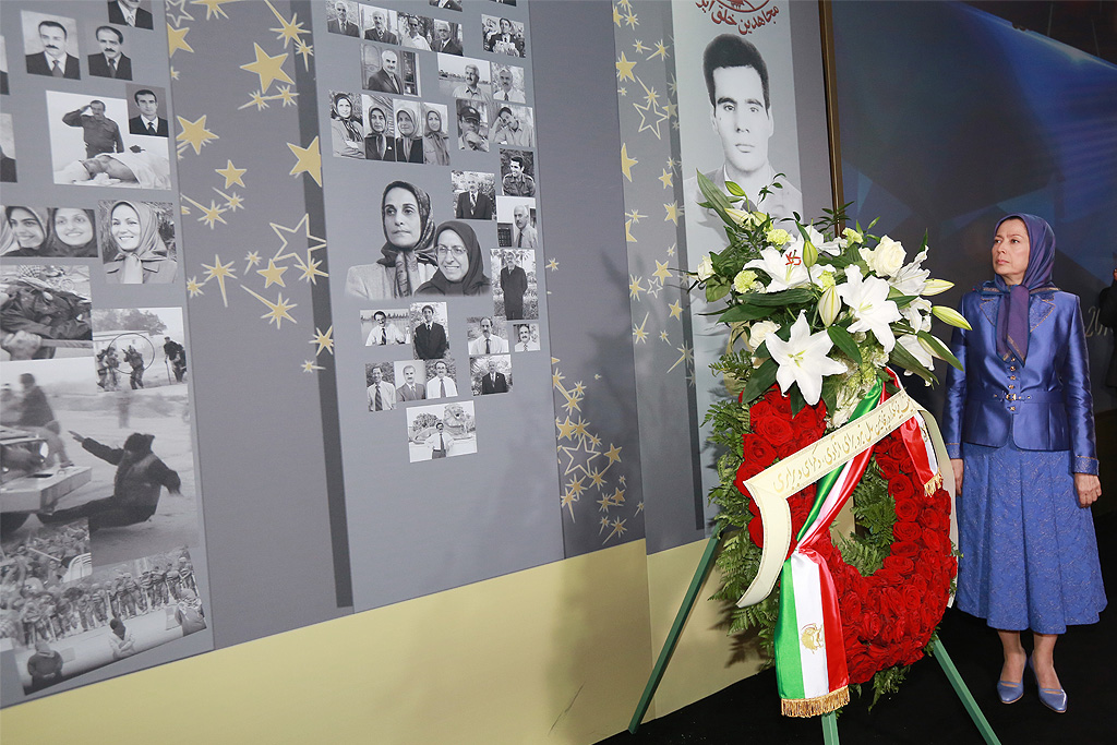 Iranian opposition leader Maryam Rajavi stands next to a memorial for 120,000 ‘martyrs of freedom in Iran’ during grand gathering in Parc des Expositions exhibition center on June 13, 2015 in Villepinte