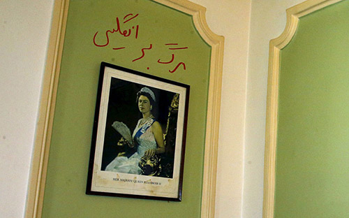 Graffiti in Persian reads 'Death to England' is seen above a picture of the Queen at the British Embassy in Tehran
